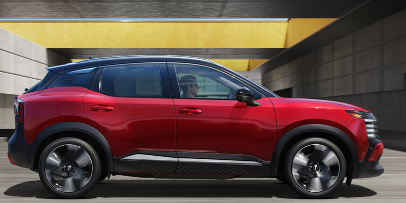 Red 2026 Nissan Kicks on road