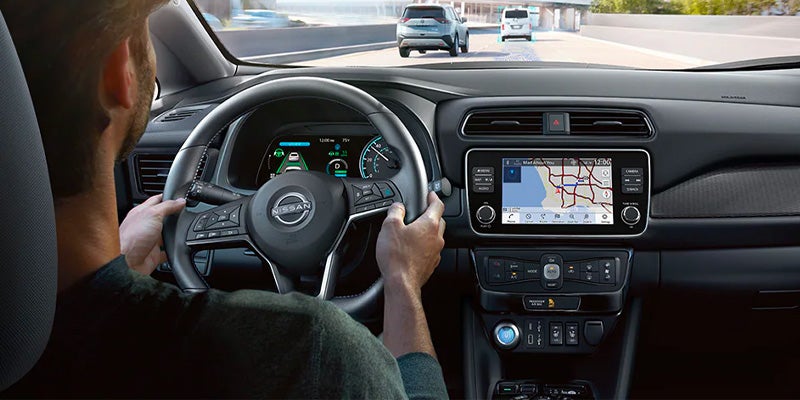 A person driving a 2025 Nissan LEAF