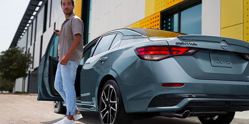 A man standing next to a 2025 Nissan Sentra