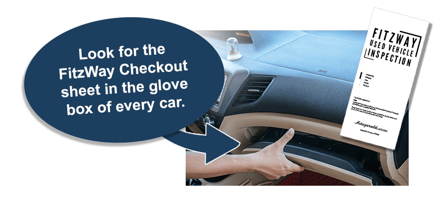 Hand opening a car’s glove box with a FitzWay Checkout inspection sheet inside